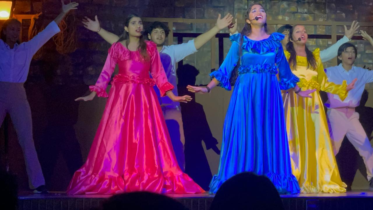 Performing on stage in fuchsia dress